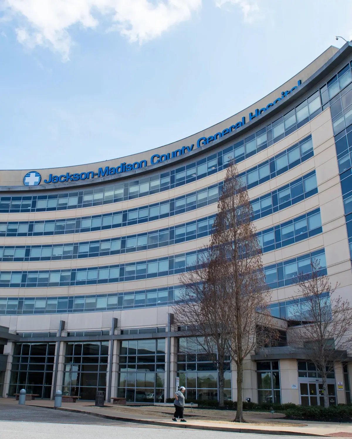 The curved exterior and main entrance of Jackson-Madison County General Hospital on a sunny day The curved exterior and main entrance of Jackson-Madison County General Hospital on a sunny day