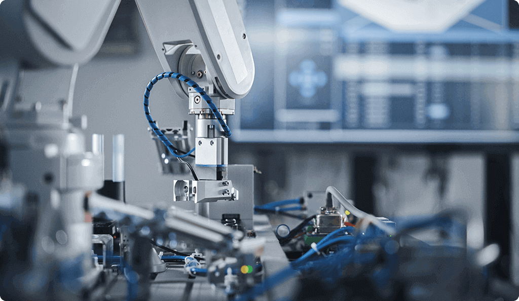 A close-up of a white industrial robotic arm performing precision work in an automated factory setting