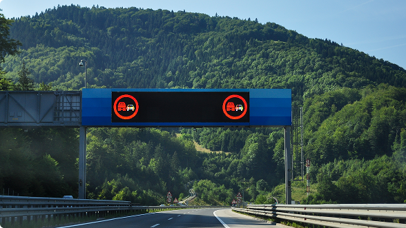 Electronic highway sign showing a no passing warning