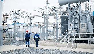 Technicians inspecting an electrical substation