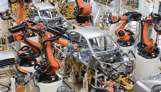 Industrial robot arms assembling a car body in a factory