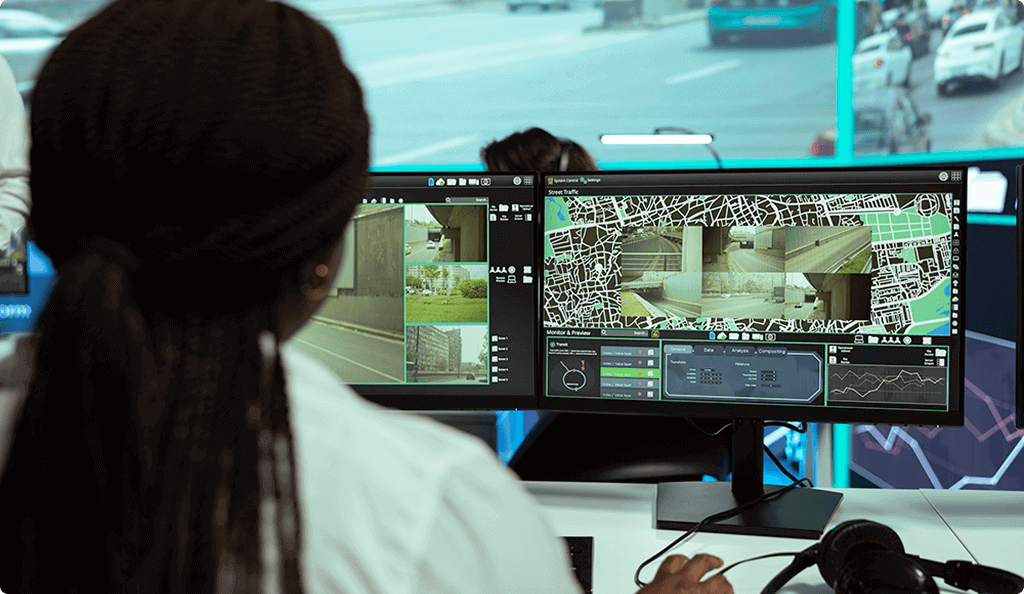 Operator monitoring street traffic and CCTV feeds in a control room